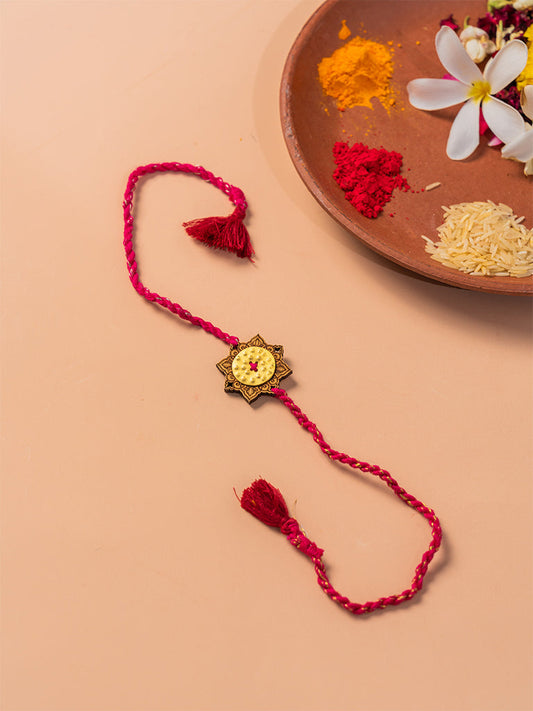 Brass Rakhi With Red Tassels
