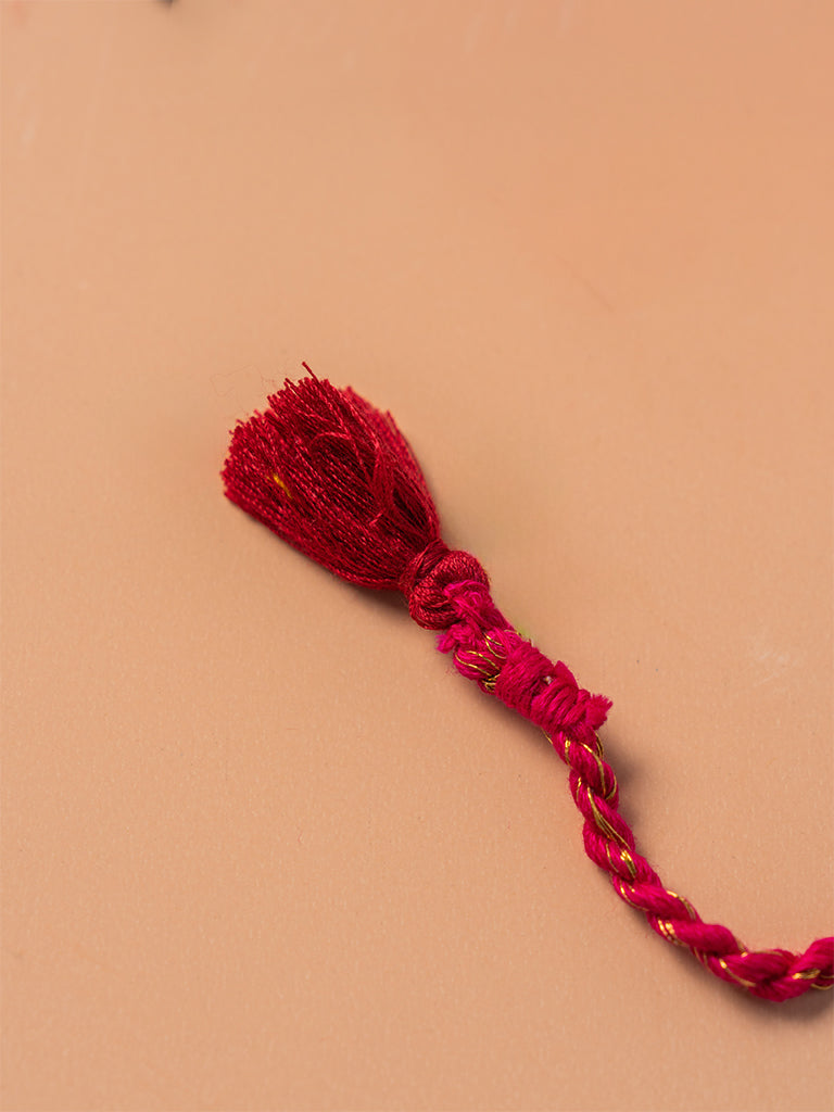 Brass Rakhi With Red Tassels