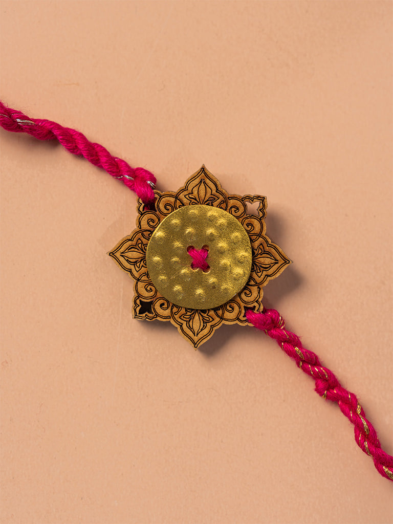Brass Rakhi With Red Tassels