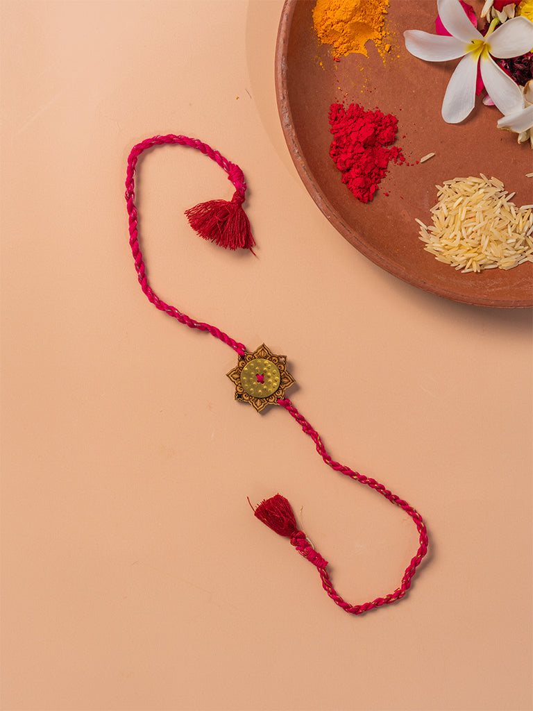 Brass Rakhi With Red Tassels
