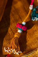 Designer wedding potli featuring brass tikki and traditional hand embroidery.