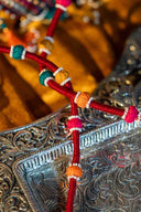 Premium multicolour embroidered potli with mirror and bead embellishments.