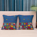 Blue artisan cushion cover with people and village motifs
