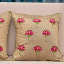 Floral cushion cover with pink lotus and green leaves

