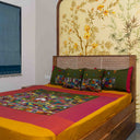 Green artisan-style bedsheet with decorative patchwork detailing

