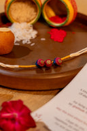 Mustard Riwaayat Triveni Handmade Rakhi with Hand-Embroidered Fabric Beads