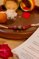 Red Riwaayat Triveni Handmade Rakhi with Hand-Embroidered Fabric Beads