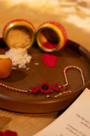 Red Karigari Noor Rakhi – Handcrafted Mirror Work Thread Rakhi