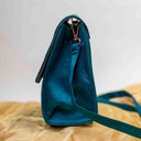 Triangular mint ethnic sling bag with traditional Rabari handwork
