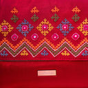 Handmade pink Rabari sling bag with bead and thread detailing
