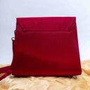 Pink triangular ethnic sling bag with traditional Rabari handwork
