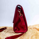Pink handcrafted sling bag with mirror shell and bead work
