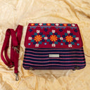Handcrafted pink triangular sling bag with traditional Indian handwork
