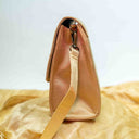 Ivory triangular ethnic sling bag by Gramshree
