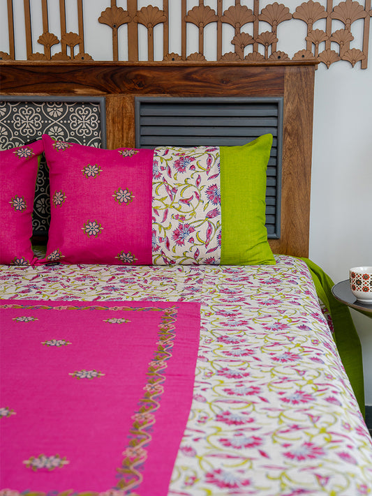 Bed with floral bedding and colorful pillows against a wooden headboard.